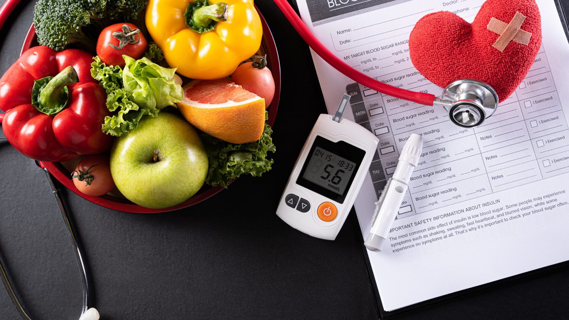 Glucose monitor on a table with food and medical notes.